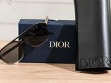 christian dior sunglasses and sunglasses case on a table with a pair of sunglasses
