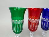 three wine glasses sitting next to each other on a table