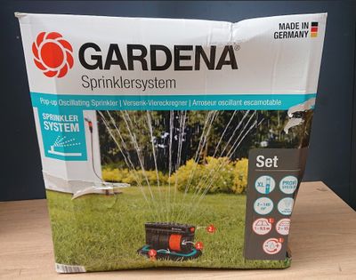 a box of gardena sprinkler system on a table
