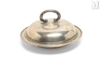a silver plate with a lid on it on a white surface