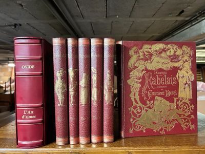 several books are lined up on a shelf in a library