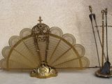 a gold fan sitting on top of a table next to other items