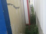 a toilet in the corner of a narrow alley