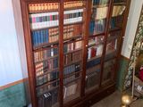 a book case with many books on it in a room