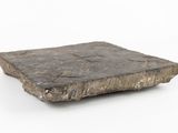 a stone block that is sitting on a white surface
