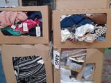 two boxes with clothes in them sitting on the floor