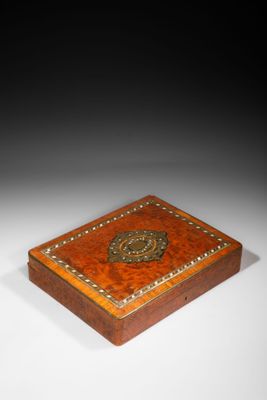 a small wooden box with a decorative design on the lid