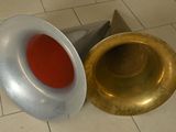 a gold trumpet and a red cup on a tiled floor