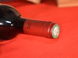 a bottle of wine on a red table cloth
