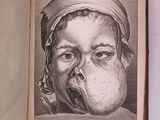 un vieux livre d'où sort un dessin représentant un bébé, par la bouche