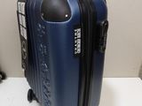 a blue suitcase sitting on top of a white table