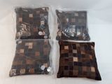three pillows in plastic bags sitting on top of a white table