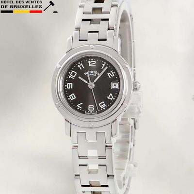 a silver watch with a black face on a white background
