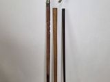 two canes that are standing next to each other on the floor