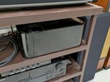 a shelf with electronics and a laptop on top of it