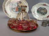 a glass decanter and a set of glasses on a tray