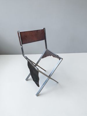 Chaise en métal chromé. Piétement en « X ».