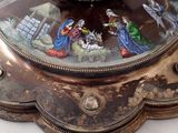 a clock that has a nativity scene on it