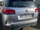 the rear end of a silver citrole parked in a parking lot