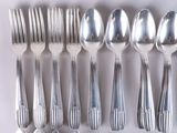 a lot of silver spoons and forks on the table
