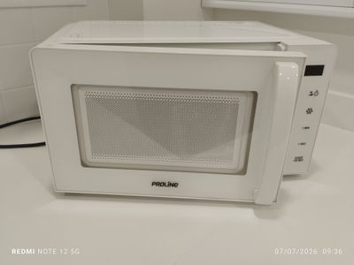 a white microwave sitting on a counter in a kitchen