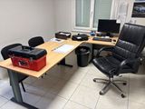 a desk with a chair and a computer on it