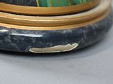 a close up of a vase with a green and gold decoration