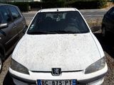 a white car parked next to a black car in a parking lot