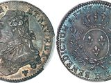 two silver coins, one with a crown and the other with a crown on it