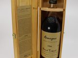 an empty bottle of alcohol in a wooden box