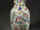 a vase that has a picture of people on it