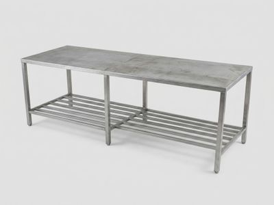 a metal bench with a shelf underneath it on a white background
