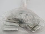 a plastic bag with a bunch of keys inside of it
