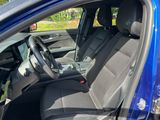 the interior of a blue car with the front seats folded down
