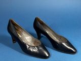 a pair of black leather shoes on a blue background