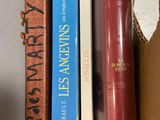 three books that are sitting in a box together
