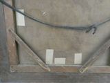 a picture of a wooden frame with a rope attached to it