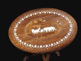 a small wooden table with a picture of animals on it