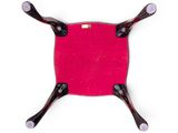 a small red chair with four legs and a red cushion