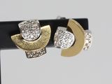 two tone gold and silver earrings with diamonds on a black stand