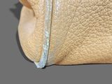 a close up of a purse on a gray surface
