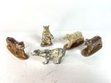five different types of animal figurines on a white surface