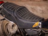 a black motorcycle parked in a garage with a red light
