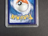 pokemon trading card in plastic case on table with black background