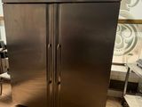 a large stainless steel refrigerator in the middle of a kitchen