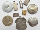 several different types of silver and gold jewelry on a white surface