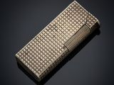 a silver cigarette case on a black background