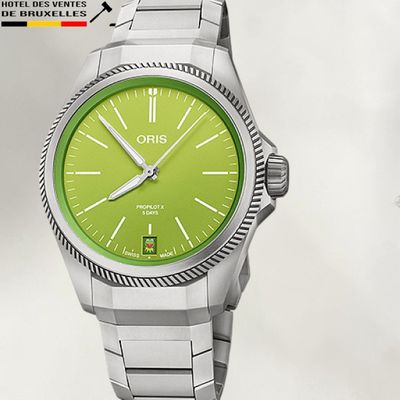 a picture of a watch with a green dial