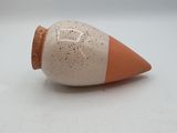 a small white and orange object on a white surface