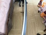 a person standing next to a bed with a sword on it